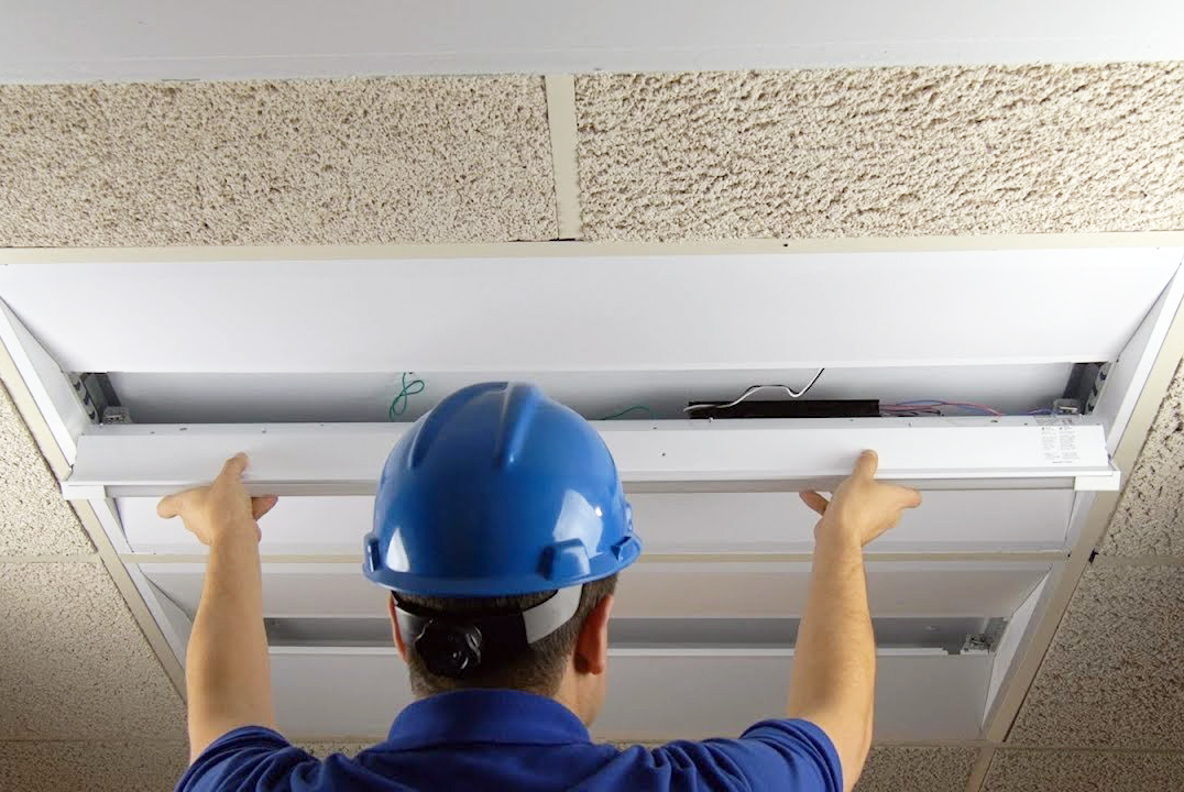 Worker installing an EvoKit LED fixture
